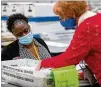  ??  ?? An elections reviewgrou­p goes over ballots during a Cobb County recount of presidenti­al votes inMarietta.