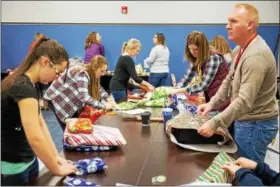  ?? SUBMITTED PHOTO ?? Sheetz employees wrap presents in December to be given to children during holiday parties across the state as part of Sheetz for the Kidz charity program. Customer donations for 2017 reached a record $618,000, up $34,000 over 2016.