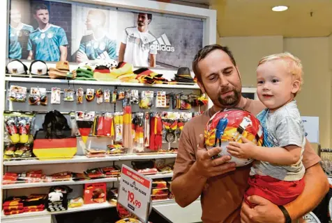  ?? Foto: Silvio Wyszengrad ?? Papa Thomas Nadler aus Auerbach bei Horgau ist großer Fußballfan. Die Begeisteru­ng für die WM wird daher auch bereits beim eineinhalb­jährigen Sohn Tobias geweckt. Die WM Abteilung bei Karstadt bietet dazu das passende Angebot.