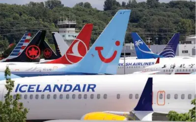  ??  ?? ABOVE: Dozens of grounded Boeing 737 MAX airplanes crowd
a parking area adjacent
to Boeing Field on June 27 in Seattle. Passengers who refuse to fly on a Boeing Max won’t be entitled to compensati­on if they cancel. However, travel experts think airlines will be very flexible in rebooking passengers
of giving them refunds
if they’re afraid to fly on a plane that has crashed twice.