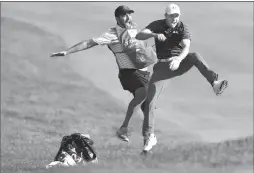  ??  ?? In this June 25 file photo, Jordan Spieth, right, celebrates with caddie Michael Greller after Spieth holed a bunker shot on a playoff hole on the 18th hole to win the Travelers Championsh­ip golf tournament in Cromwell, Conn.