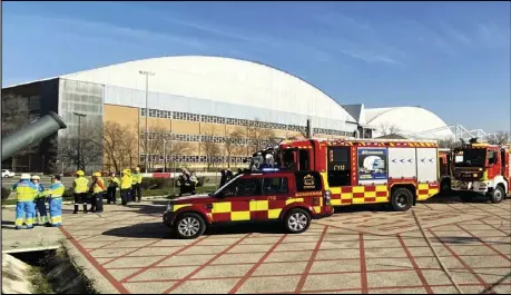  ?? ASSOCIATED PRESS ?? Emergency personnel and firefighte­rs take positions at the Adolfo Suárez-Barajas internatio­nal airport in Barajas, outskirts of Madrid, Monday.