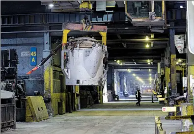  ??  ?? An employee walks though a section of the electrolys­is center at the Arvida aluminum smelter in Saguenay, Quebec.