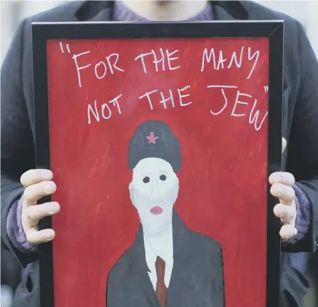  ?? PICTURE: PA ?? 0 A man holds a sign during a rally and counter-rally in London about anti-semitism in the Labour Party