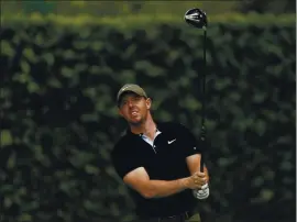  ?? DAVID J. PHILLIP — THE ASSOCIATED PRESS ?? Rory McIlroy watches his tee shot on the second hole Wednesday during a practice round for the Masters, the only one of golf’s major tournament­s he has yet to win.