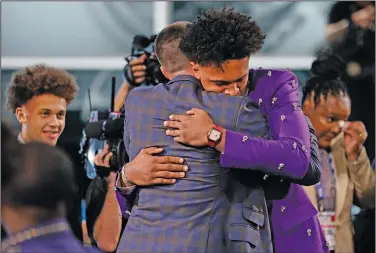  ?? Associated Press ?? Top pick: Paolo Banchero, hugs family and friends after being selected number one overall by the Orlando Magic in the NBA basketball draft Thursday in New York.