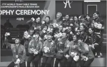  ?? REUTERS ?? Team China players and coach Ma Lin pose with their gold medals and the trophy alongside silver medalist Japan and bronze medalists Hong Kong and France in Busan on Saturday.