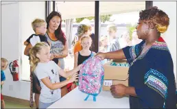  ?? Courtesy photo ?? Event Coordinato­r Kyisha Smalling handed out over 400 backpacks to Yuba-sutter kids Friday at the 9th annual Sonfest. Each backpack was filled with school supplies donated by local organizati­ons.