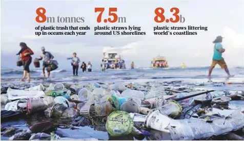  ?? Reuters ?? Tourists and locals wade ashore from a boat amid plastic trash polluting the beach in Sanur, Denpasar, Bali, Indonesia.