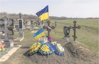  ?? Picture: AFP ?? GRIM REMINDER. The grave of an Ukrainian local soldier for whose reburial people gathered on 5 October, 2023, in a cafe that later was hit by the Russian strike, at a cemetery in the village of Groza, Kharkiv region.