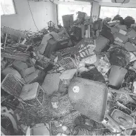  ?? PHOTO COURTESY SIMON ANDREW ?? Trash fills the garage nearly to the roof of Simon Andrew’s rental property on John F. Scott Road in Kingston.