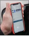  ?? (AP/Nati Harnik) ?? Precinct captain Carl Voss of Des Moines displays the caucus reporting app on his phone Tuesday.