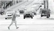  ??  ?? A pedestrian crosses Andrews Avenue at Las Olas Boulevard in Fort Lauderdale. Vehicles traveled fewer miles last year, but pedestrian deaths remained high.