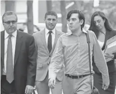  ?? MARK LENNIHAN, AP ?? Martin Shkreli, second from right, arrives at Brooklyn federal court in New York this month with members of his legal team.