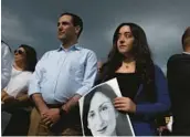  ?? JOANNA DEMARCO/GETTY ?? Members of the public stand at a vigil for journalist Daphne Caruana Galizia on Sunday at the spot where she was killed in Bidnija, Malta.