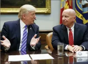  ?? EVAN VUCCI — THE ASSOCIATED PRESS ?? In this photo, Rep. Kevin Brady, R-Texas, right, listens as President Donald Trump speaks during a meeting with members of the House Ways and Means committee in the Roosevelt Room of the White House in Washington.