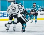  ?? Tony Avelar Associated Press ?? JEFF CARTER (77) tries to keep his feet as the Sharks’ Logan Couture runs into him in open ice.