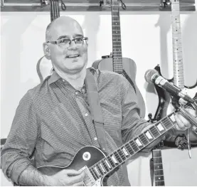  ?? ELIZABETH PATTERSON/CAPE BRETON POST ?? Dr. Tom Hewlett is a Sydney-based nephrologi­st who also enjoys playing the guitar in his spare time.