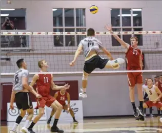  ?? GARY YOKOYAMA, THE HAMILTON SPECTATOR ?? McMaster’s leaping Craig Ireland and Ohio State’s Chase Moothart challenge each other at the net. McMaster went on to defeat Ohio State in three straight sets Sunday afternoon.