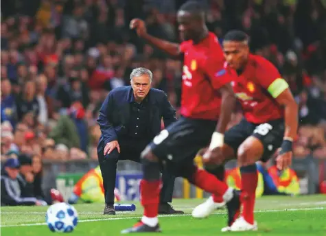  ?? Reuters ?? Manchester United manager Jose Mourinho watches the action closely as Manchester United’s Eric Bailly and Antonio Valencia plan the next move during the Champions League clash against Valencia at Old Trafford on Tuesday. The match ended 0-0.