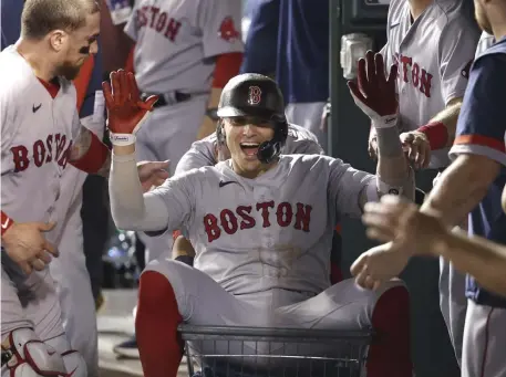  ?? Getyy imageS pHOtOS, ?? COMING UP CLUTCH: Red Sox second baseman Kiké Hernandez celebrates his ninth inning two-run home run on Saturday in Washington, D.C. Below, Tanner Houck prepares to face the Nationals before first pitch.