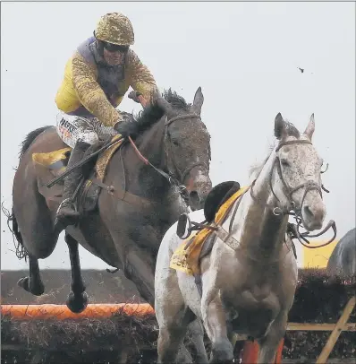  ??  ?? Jack Quinlan and Kalashniko­v on their way to victory in the Betfair Handicap Hurdle at Newbury on Saturday.