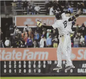  ?? AP PHOTO ?? RISING TO OCCASION: Starlin Castro celebrates with Didi Gregorius (18) after the Yankees’ victory against the Royals last night in New York.