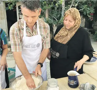  ?? LISA KADANE ?? Blake Ford kneads dough for fresh pitas at the Beit Sitti school in Jordan.