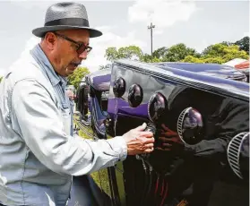  ?? Photos by Elizabeth Conley / Staff photograph­er ?? Lou Herrera lifts the hood of his 1935 Cadillac LaSalle to show off the engine during a lowrider gathering at Knights of Columbus Park on Saturday.