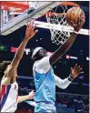  ?? RINGO H.W. CHIU / AP ?? Los Angeles Clippers guard Reggie Jackson, right, goes to the basket under pressure from Detroit Pistons guard Cade Cunningham during an NBA game Friday in L.A.