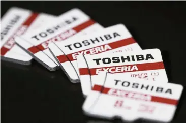  ?? — Bloomberg ?? Valued chips: Toshiba Corp’s Exceria micro secure digital high capacity (microSDHC) memory cards are arranged for a photograph in Tokyo, Japan. Apple is in talks to invest about US$3bil in Toshiba Corp’s memory chips business as part of a consortium...