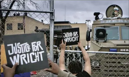  ?? Los Angeles Times ?? PROTESTERS gather outside the Brooklyn Center Police Department in Minnesota on Wednesday to call for justice for Daunte Wright, who was killed by a police officer during a traffic stop three days earlier in the Minneapoli­s suburb.