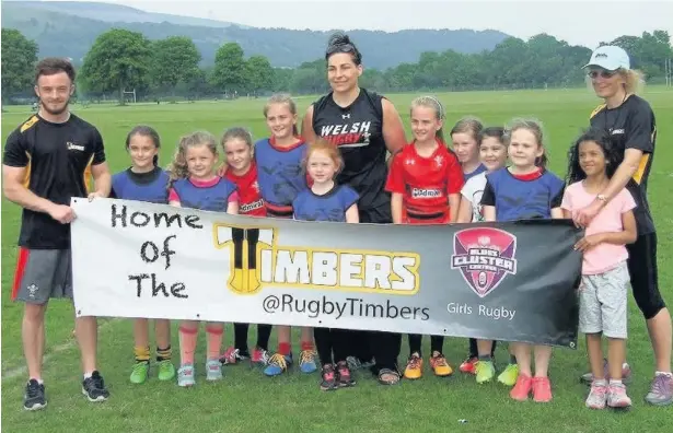  ??  ?? Amy Evans, centre, meets young players during her visit to the Timbers rugby centre in Aberdare