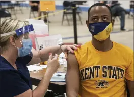  ?? PHIL LONG — THE ASSOCIATED PRESS ?? Kent State University student Marz Anderson gets his Johnson & Johnson COVID-19 vaccinatio­n from Kent State nurse Beth Krul in Kent, Ohio, Thursday. U.S. colleges hoping for a return to normalcy next fall are weighing how far they should go in urging students to get the COVID-19 vaccine, including whether they should — or legally can — require it.