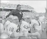  ?? AP PHOTO/FILE ?? In this Jan. 1, 1971, photo, Notre Dame coach Ara Parseghian is carried off the field by his players after defeating Texas, 24-11, in the Cotton Bowl. Parseghian, who took over a foundering Notre Dame football program and restored it to glory with two national championsh­ips in 11 seasons, died Wednesday.