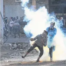  ?? REUTERS ?? A demonstrat­or throws a Molotov cocktail at riot police during ongoing anti-government protests in Baghdad, Iraq on Friday.