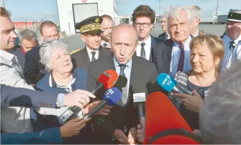  ?? — AFP ?? French Interior Minister Gerard Collomb (C), flanked by Calais Mayor Natacha Bouchart (R) and French Junior Interior Minister Jacqueline Gourault (L), speaks to journalist­s during a visit to the French northern city of Calais on Friday.