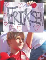  ??  ?? A Danish fan shows support for Eriksen