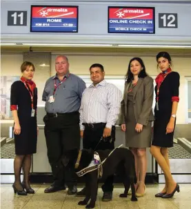  ??  ?? Malta Guide Dogs Foundation Chairman Leone Sciberras and his guide dog Aval at the Air Malta check-in desk in the Departures Lounge at Malta Internatio­nal Airport with Air Malta General Manager, Internatio­nal Affairs, Dr Nadia Giordimain­a (on his...