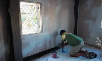  ?? SARAH COLE HANDOUT PHOTO VIA AP ?? In this 2017 photo provided by Sarah Cole, a specialty craftsman repairs plaster on the walls at the James Blake House in Boston.