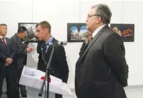  ?? (Ugar Kavas/Reuters) ?? RUSSIAN AMBASSADOR to Turkey Andrei Karlov (right) prepares to speak at an art gallery in Ankara on Monday, shortly before he was murdered by an off-duty policeman.