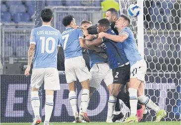  ?? AFP ?? Lazio and Inter players scuffle after Lazio’s Felipe Anderson, second left, scored his team’s second goal.