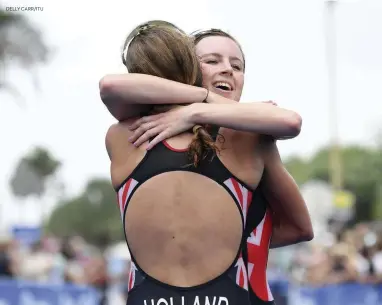 ?? DELLY CARR/ITU ?? Elite British women Georgia Taylor-Brown and Vicky Holland hug it out after crossing the finish line of the ITU Mooloolaba World Cup on 14 March. Holland took the title after beating Taylor-Brown into second by 15secs.