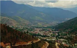  ??  ?? Bhutan’s border runs along a treacherou­s seam of the Eastern Himalayan mountain range.