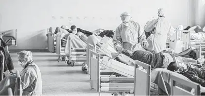  ?? ALESSANDRO GRASSANI/THE NEW YORK TIMES ?? A makeshift emergency room filled with patients is set up amid the coronaviru­s outbreak in March in Brescia, Italy.