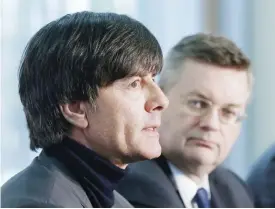  ??  ?? FRANKFURT: Coach of German national soccer team Joachim Loew, left, speaks as the President of German soccer federation Reinhard Grindel looks on after signing a new contract in Frankfurt, Germany, yesterday. — AP