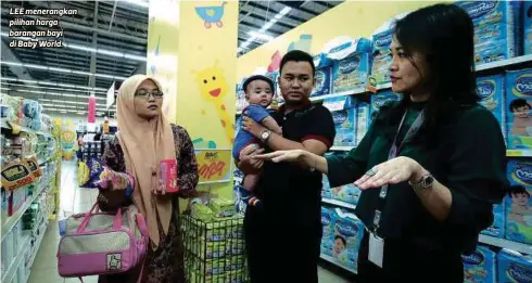  ?? FOTO ?? LEE menerangka­n pilihan harga barangan bayi di Baby World.