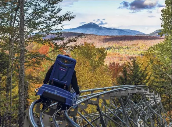  ?? Courtesy of ORDA ?? A rider tries out Lake Placid's new Cliffside Mountain Coaster, which opened Sunday and will operate on weekends throughout the year.