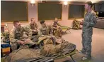  ??  ?? Members of the Third Combat Support Services battalion get briefed at the Timaru Fire Station.