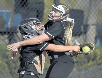  ?? Photos by Andy Cross, The Denver Post ?? Fossil Ridge catcher Kodi Alvord, left, and pitcher Nikki McGaffin, right, celebrate after defeating Cherokee Trail to win the Class 5A state softball championsh­ip game at Aurora Sports Park on Saturday.